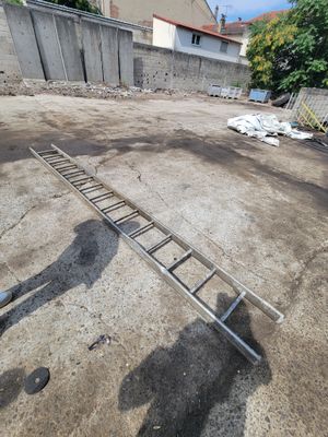 a man that is standing next to a ladder