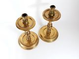 pair of antique brass candlesticks on a white background