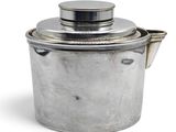 a silver pot with a lid on a white surface
