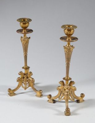 pair of antique brass candlesticks on stand on white background