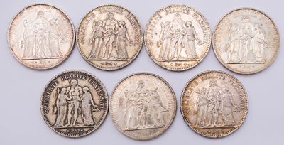 six different types of silver coins on a white surface