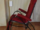 a red chair that is sitting in front of a radiator