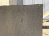 a piece of concrete sitting on the ground next to a building