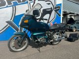 a blue motorcycle parked in front of a building