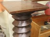 a wooden table with a lamp on top of it in a room
