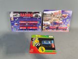 two boxes of toys on a table with a train on it