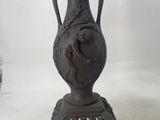 an image of a vase with flowers in it on a stand