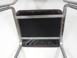a chair that has a black seat and a metal frame