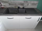 a kitchen sink with two black sinks in it