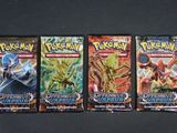 trois paquets de cartes à collectionner Pokémon posés sur une table