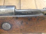 an old gun with a wooden handle on a wooden table