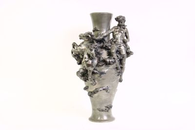 a silver vase that has a bunch of flowers in it
