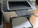 a printer sitting on top of a desk next to a cell phone