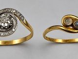 two gold rings with diamonds and a stone in the middle
