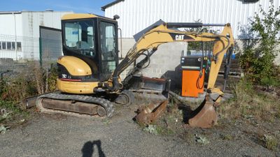 a small excavator that is sitting in the dirt