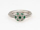 a white gold ring with emerald and diamonds