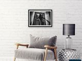 a chair and a lamp in a room with a brick wall