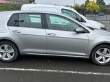 a silver car that is parked in a parking lot