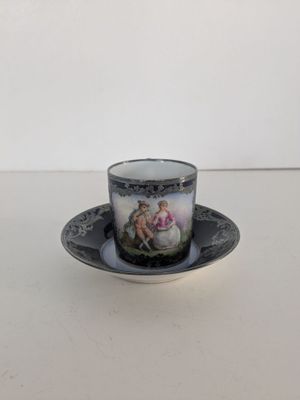 a close up of a cup and saucer on a table