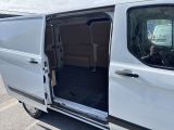 a white van with its doors open and a person taking a picture