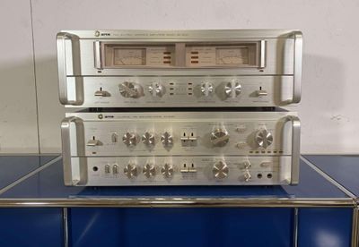 a silver stereo system sitting on top of a blue table