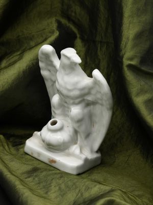 a white statue of an angel on a green cloth