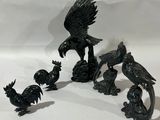 quatre figurines d'oiseaux posées sur une table