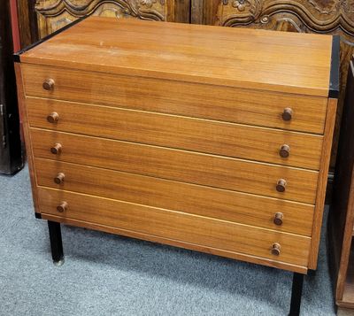 a wooden chest of drawers in a room