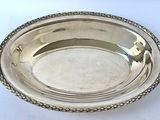 an antique silver plate on a white table with a white background