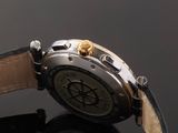 a close up of a watch on a black surface