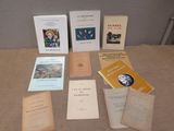several books are sitting on a table in front of a wall