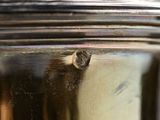 a close up of a silver tea pot with a lid