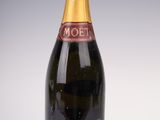 an image of a bottle of moet champagne on a white surface