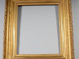 an antique gold frame with a decorative pattern on the edge