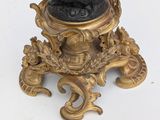 an image of a statue of a man holding a fish on a pedestal