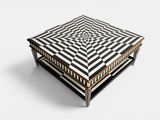 a black and white coffee table with a geometric design on top