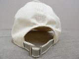 a white hat with a metal buckle on the side of it