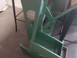 a green machine that is sitting on the floor