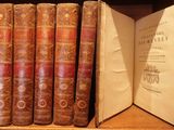 many old books sitting on a shelf in a library