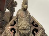 a bronze statue of a man sitting on top of a box