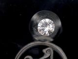 a silver ring with a diamond in it on a black background