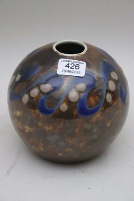 a vase with a tag on it sitting on a table
