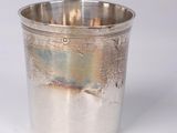 silver plated cup on a white surface with a white background