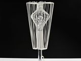 a white wire lamp that is on a white table