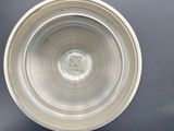 a white bowl sitting on top of a black table
