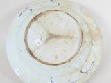a white plate with blue designs on it on a white surface