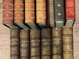 several old books are stacked on top of each other on a table