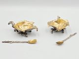 two spoons and a spoon rest on a table