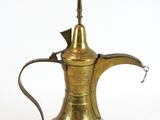 an old brass coffee pot with a handle on a white background