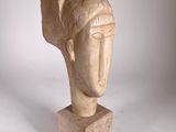 sculpture of a woman ' s head on a marble base
